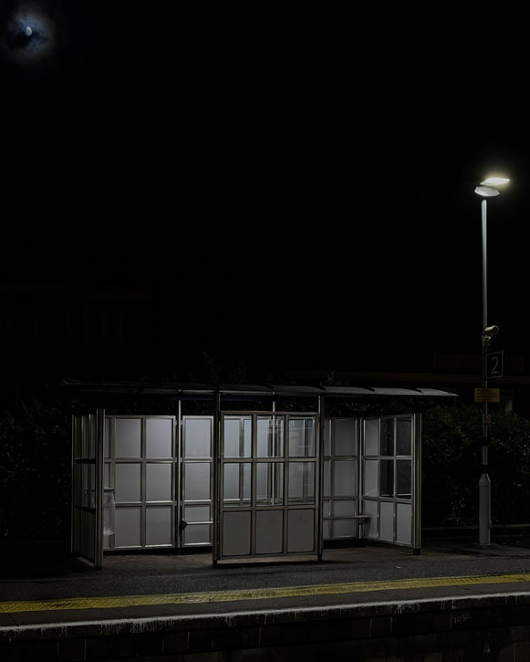 An empty train station at night, an empty shelter seems ghostly.