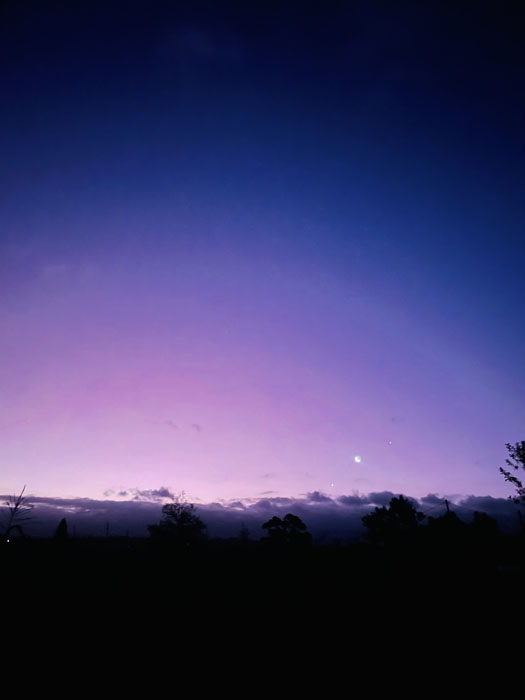 Photo shows a twilight view of a sunset fading into night.